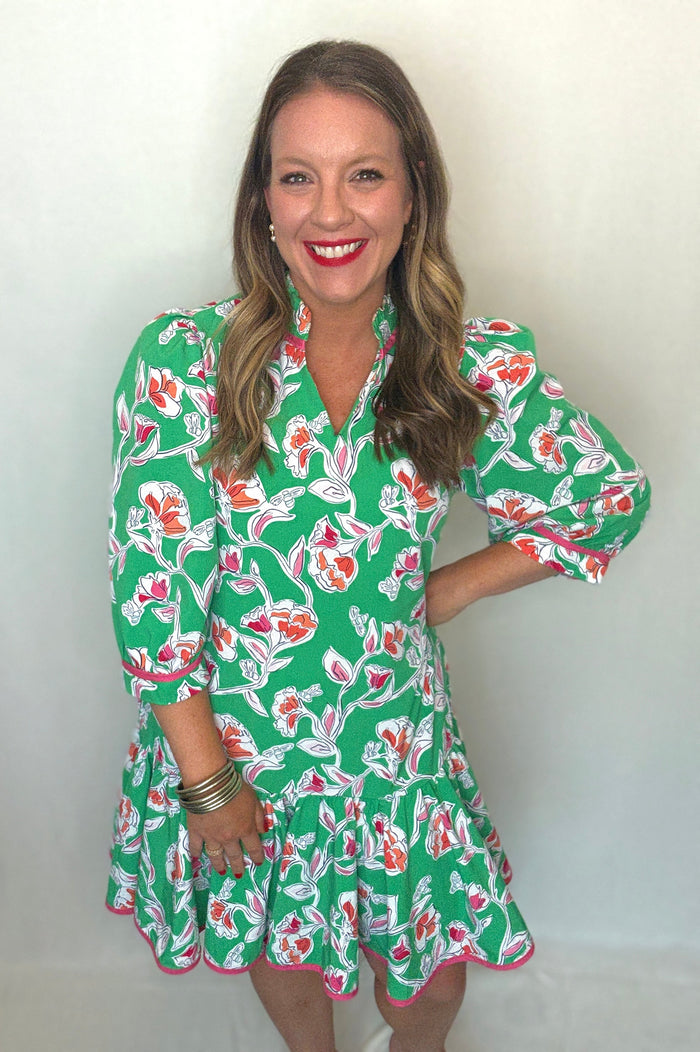 Woman wearing a green floral dress against a white background