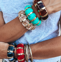 Stretch Resin and Acrylic Bracelets in Clear, Black, and Ranch Red stacked on wrists